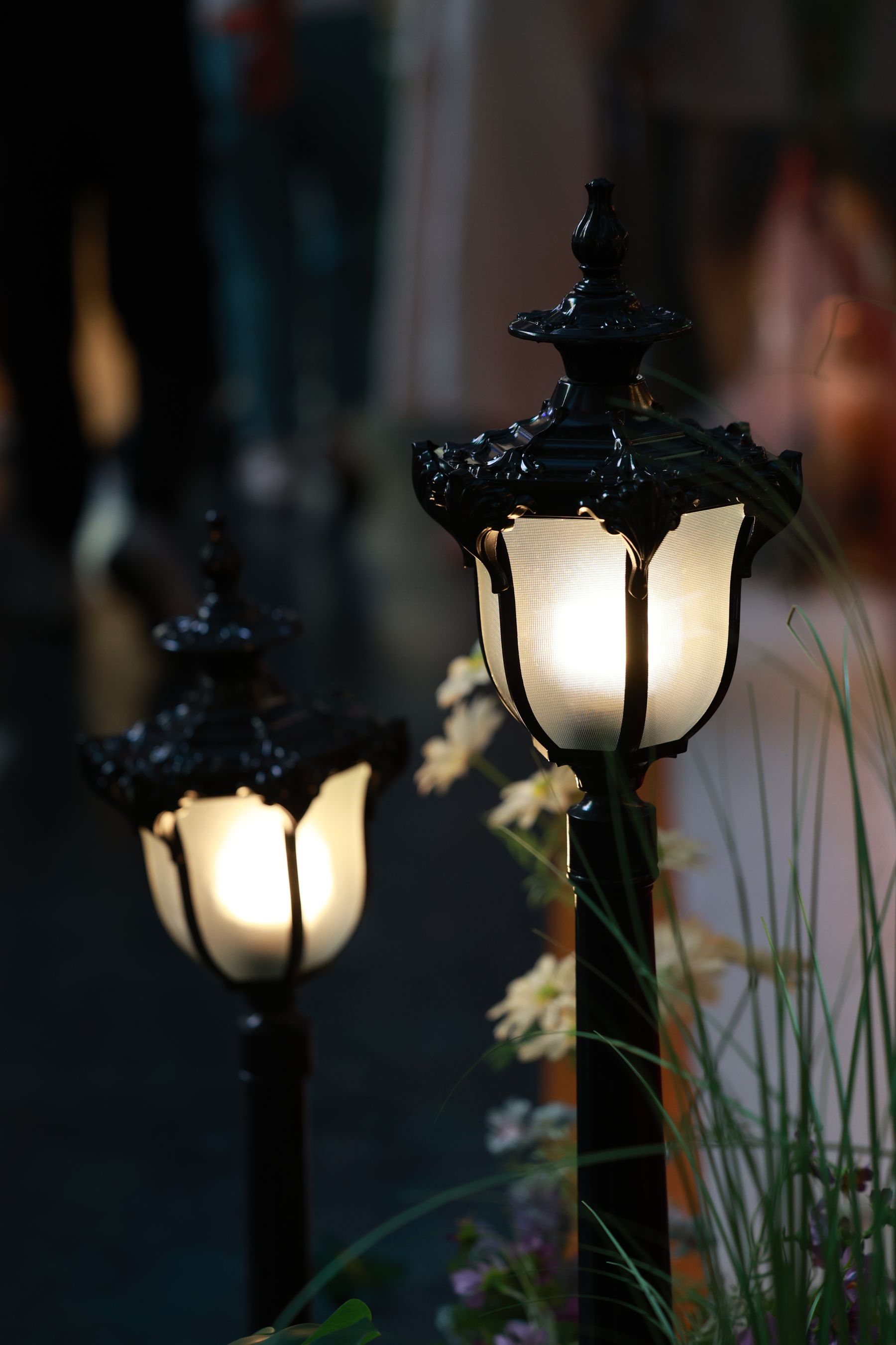 Warm path lights glowing along a garden walkway at dusk