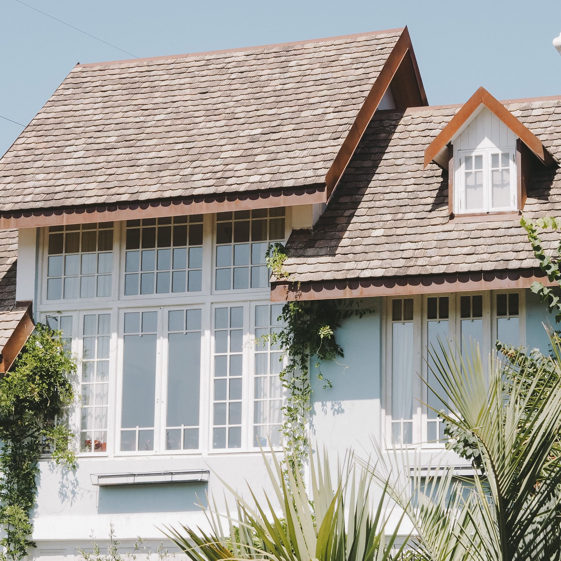 Shingled roof and dormer on a well-kept suburban home